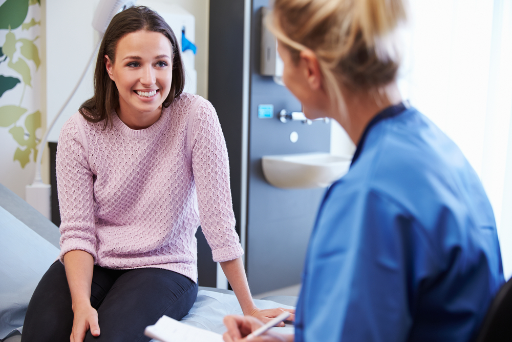 woman patient talking with female medical provider during appointment