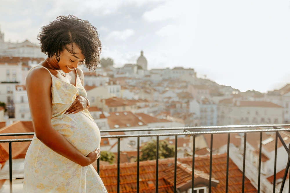 pregnant woman smiling outside.